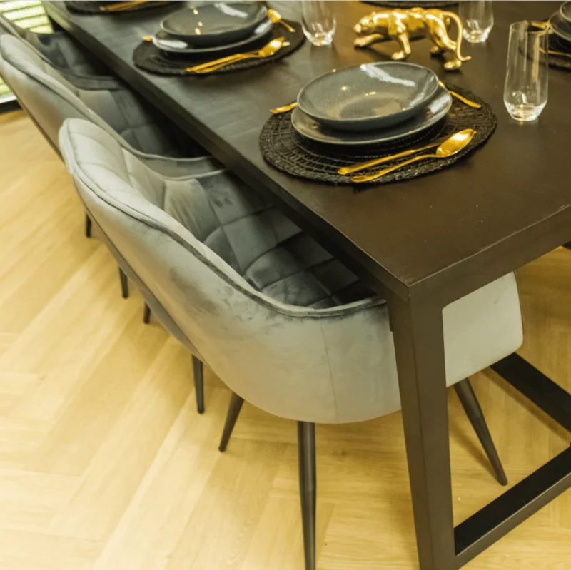 Close-up from above of a set dining table with grey chairs