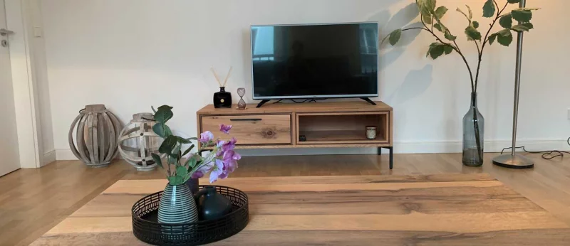 An inviting living room featuring a TV and wooden coffee table