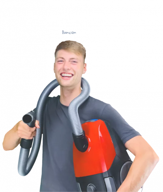 Dennis smiling and holding a drill