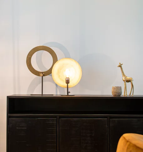 A table adorned with a lamp and a cute giraffe figurine