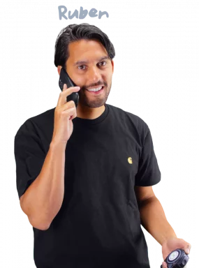 Ruben holding a tape measure and calling on the phone