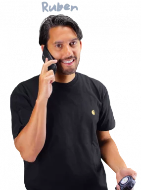 Ruben holding a tape measure while on the phone