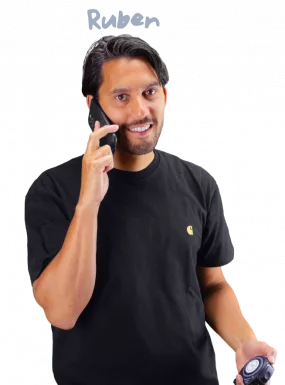 Ruben holding a tape measure while on the phone