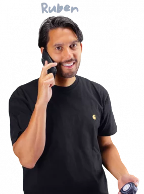 Ruben holding a tape measure while on the phone