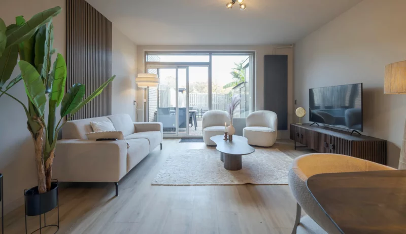 Living room with coffe table, couches, chairs and a television