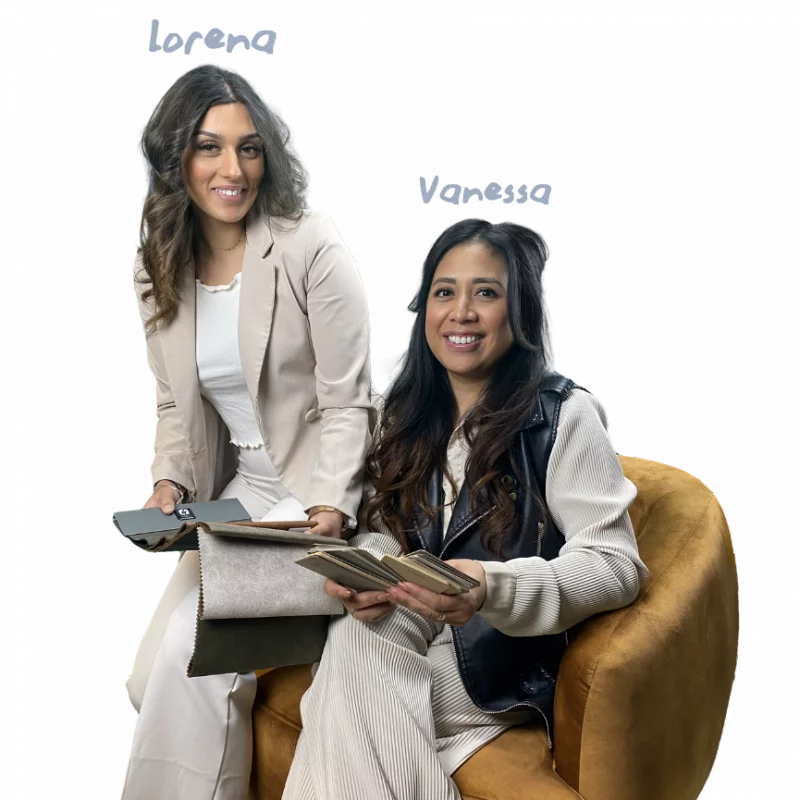 Lorena and Vanessa sitting in a chair, holding colour swatches