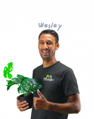 Wesley giving a thumbs up and holding a plant