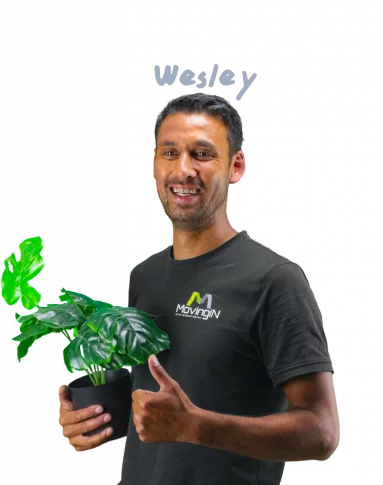Welsye giving a thumbs up and holding a plant