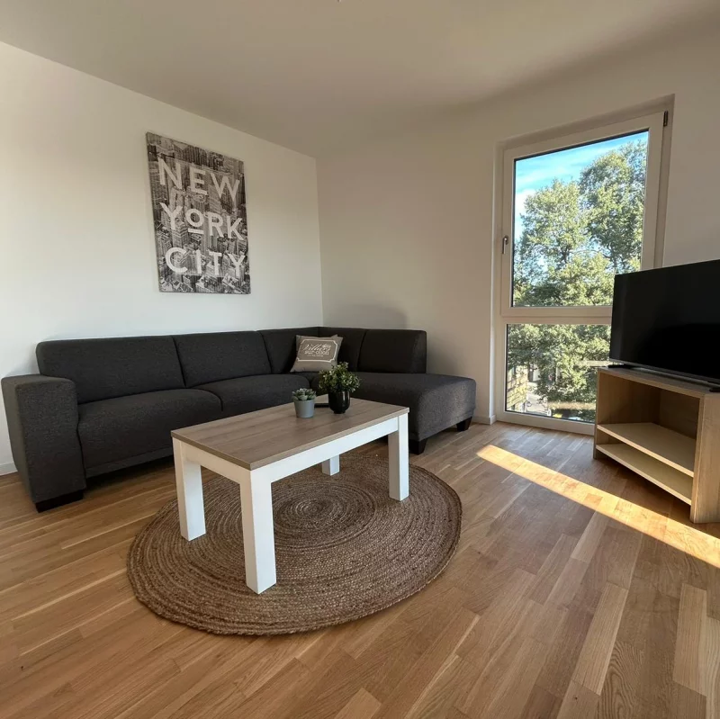 An inviting living room featuring a couch, coffee table, and television