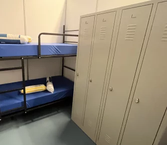 Inside the emergency reception with bunkbeds and lockers